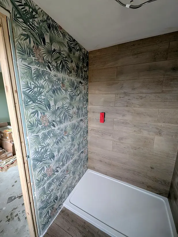 Finished shower with botanical feature wall and wood effect tiles