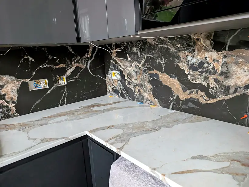 Finished black marble effect kitchen splashback