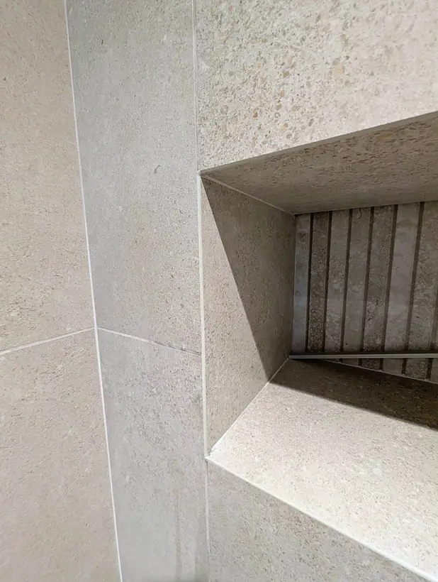 Mitred edges around a shower niche