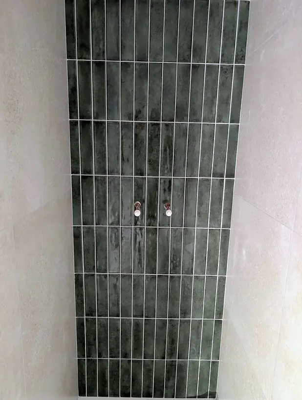 Green vertical stacked shower tiles